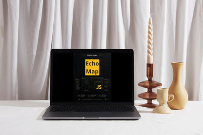 A dark gray laptop displaying a 'Echo Map JS' dashboard on its screen, styled on a white surface with decorative ceramic vases and a tall spiral candle holder against a draped white curtain background.